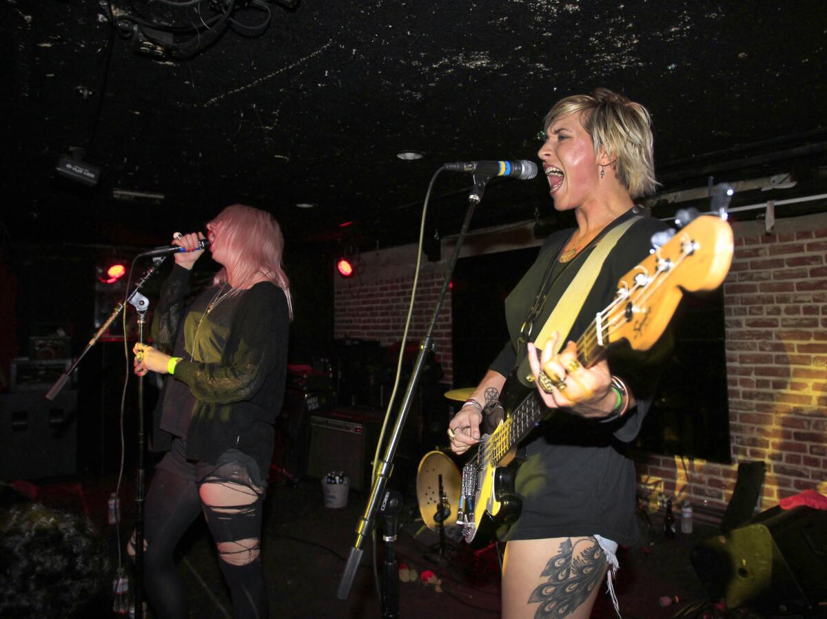 Lead singer Mish Way, left, and bassist Hether Fortune of Canadian punk band White Lung perform at Los Globos in Los Angeles on July 23, 2014.