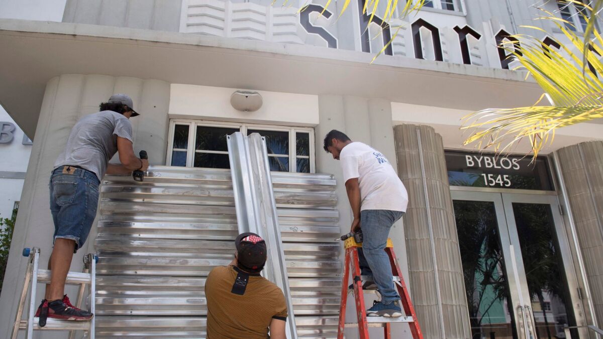 Workers put up storm shutters in preparation of Hurricane Irma in Miami Beach Friday in preparation for Hurricane Irma.