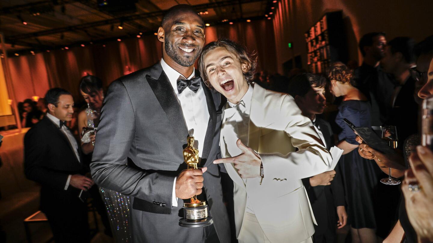 Kobe Bryant holds onto his Oscar as he poses with nominee Timothée Chalamet at the Governors Ball on Sunday.