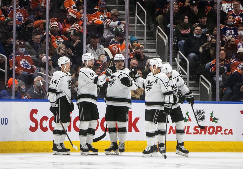 Los Angeles Kings players celebrate a goal against the Edmonton Oilers during the second period of an NHL hockey game in Edmonton, Alberta, Sunday, Dec. 5, 2021. (Jason Franson/The Canadian Press via AP)