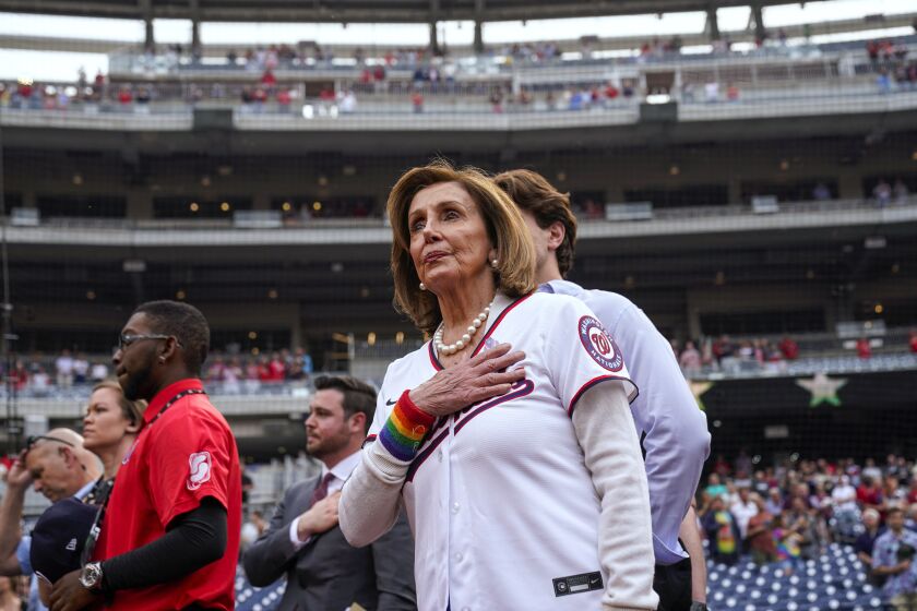 Rep. Nancy Pelosi, D-Calif., stands during the national anthem after throwing out a ceremonial first pitch before a baseball game between the Washington Nationals and the Arizona Diamondbacks at Nationals Park, Tuesday, June 6, 2023, in Washington. The Nationals celebrated Pride month with their 18th Night OUT event. (AP Photo/Alex Brandon)
