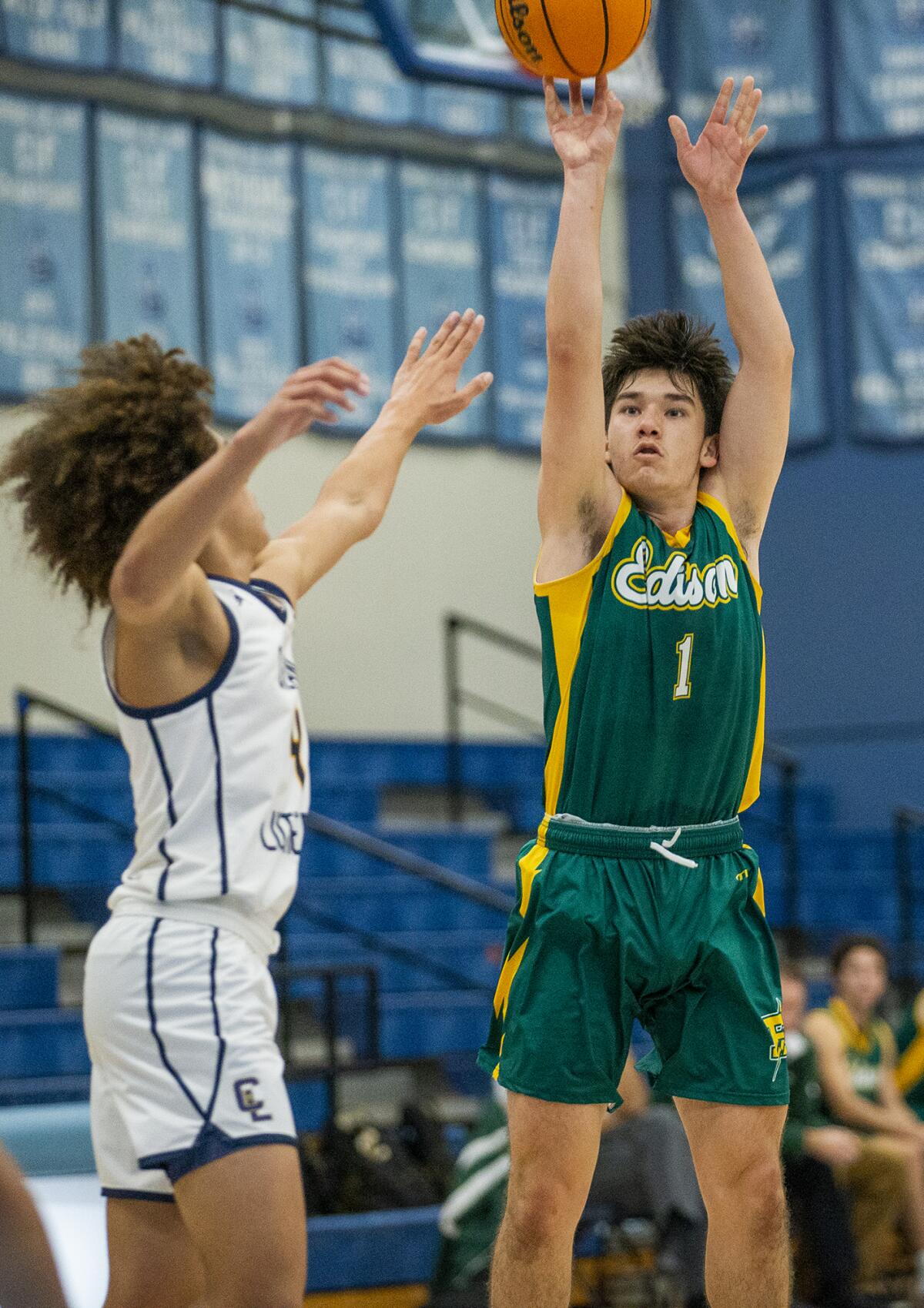 Edison's Kaz Hampton takes a shot over Crean Lutheran's Kaiden Bailey in the Corona del Mar Beach Bash on Wednesday.