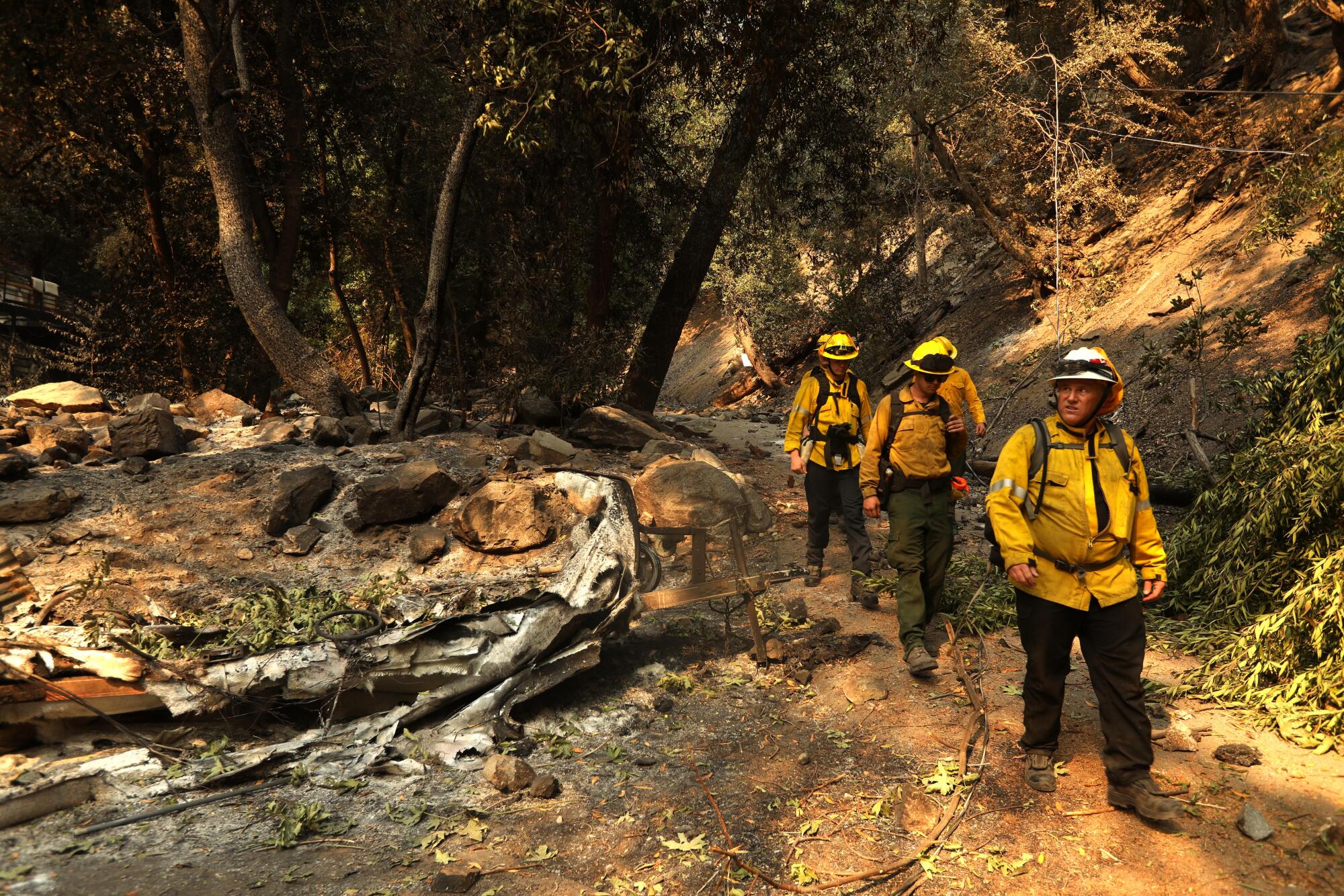 Asst. Chief Shawn Cate and his crew with Mount Baldy Fire Department, survey the damage to homes from the Bridge fire.