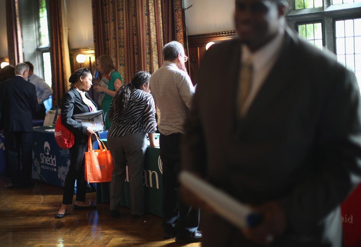 Military veterans search for work at a job fair in Chicago.