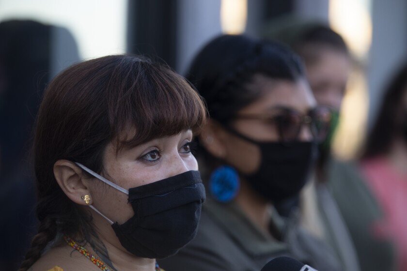 Iris De Anda, 41, a member of Reclaim and Rebuild Our Community, speaks during a press conference in the El Sereno.