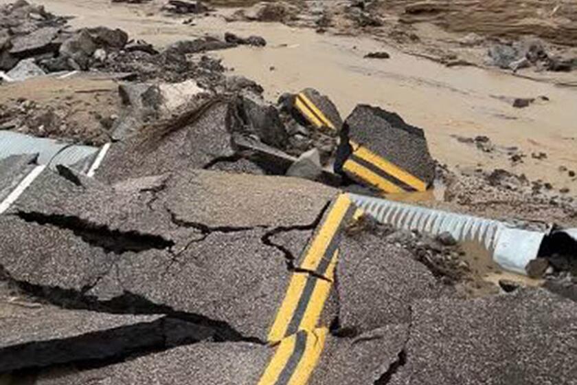 Fast-moving flood waters buckled and damaged the roadway inside the Mojave National Preserve.