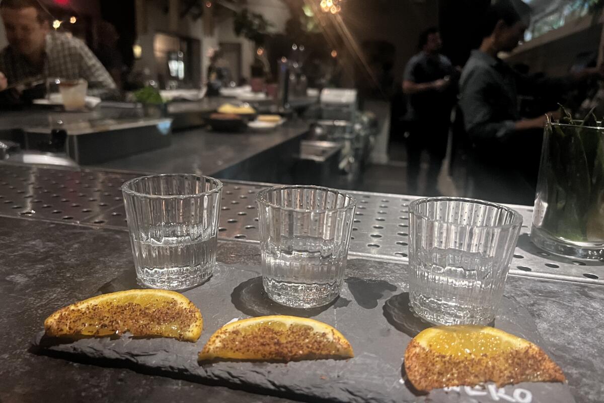 Mezcal flights at Gracias Madre come with a thin orange wedge that are rimmed with a chili pepper spice blend.