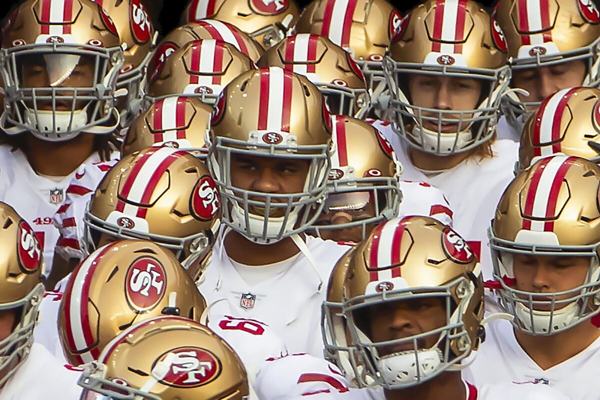 San Francisco 49ers gather before taking the field to play the New England Patriots on Oct. 25 in Foxborough, Mass. 