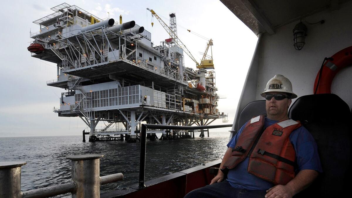 A crew member arrives by boat at an oil platform near Santa Barbara.