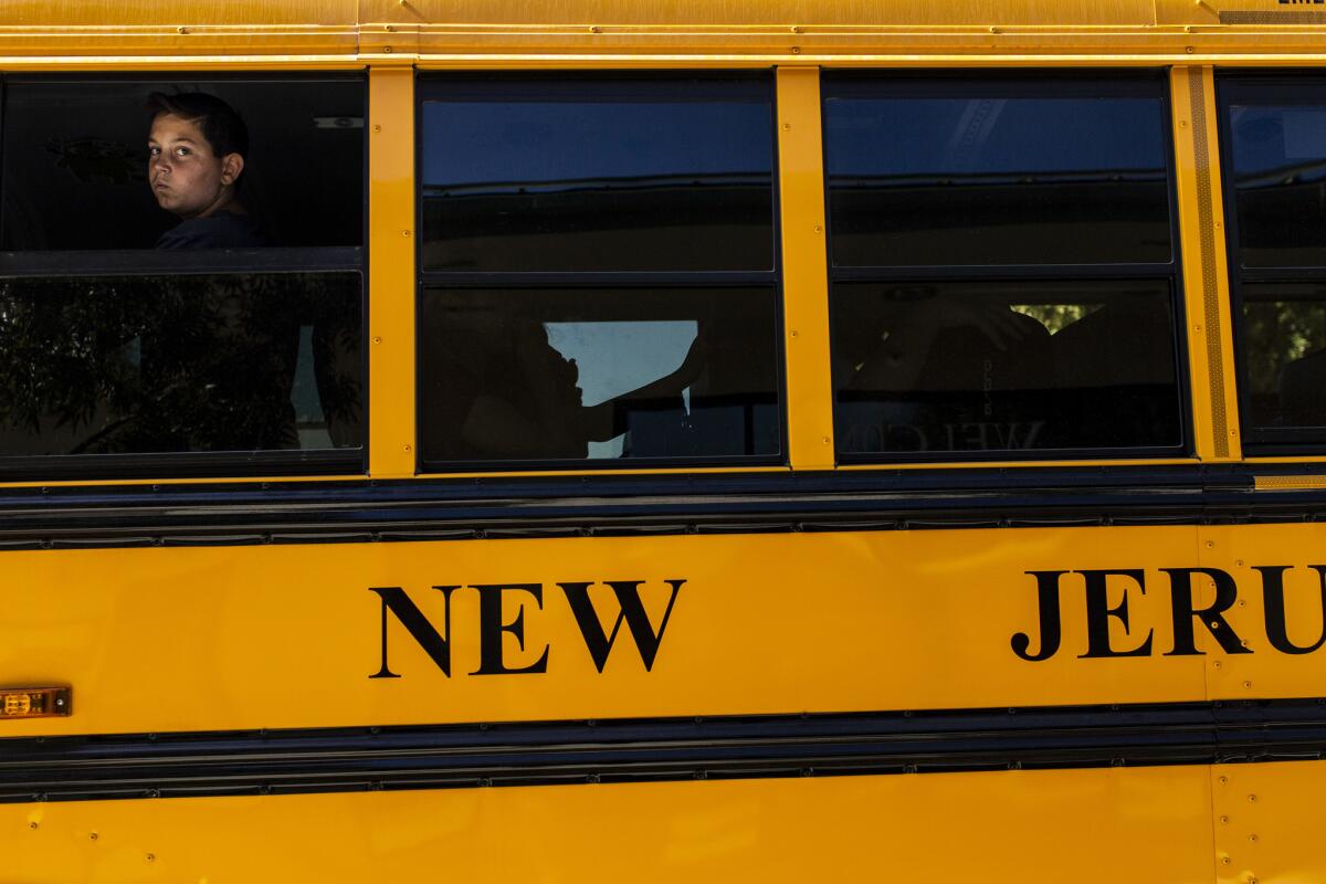 Students board a yellow New Jerusalem Elementary School District bus. The district has made plenty from charter school fees, but it was chastised for lax oversight after a charter operation failed.