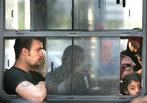 Residents of the Beirut suburb of Dahieh and Chariah are loaded into buses bound for Tripoli in North Lebanon hours after the IDF dropped leaflets warning them to evacuate their neighborhoods.