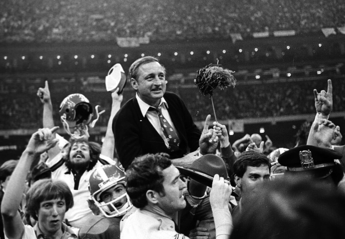 FILE - Georgia football coach Vince Dooley is carried off the field after Georgia defeated Notre Dame 17-10 in the Sugar Bowl college football game Jan. 1, 1981, in New Orleans. Dooley loves history _ especially the kind he says favors his beloved Bulldogs. Dooley believes a rematch will work in Georgia's advantage against Alabama in the College Football Playoff title game on Monday night in Indianapolis. Dooley also has faith Georgia's defense will fare better in its second chance against Alabama quarterback Bryce Young. (AP Photo/Gene Blythe, File)