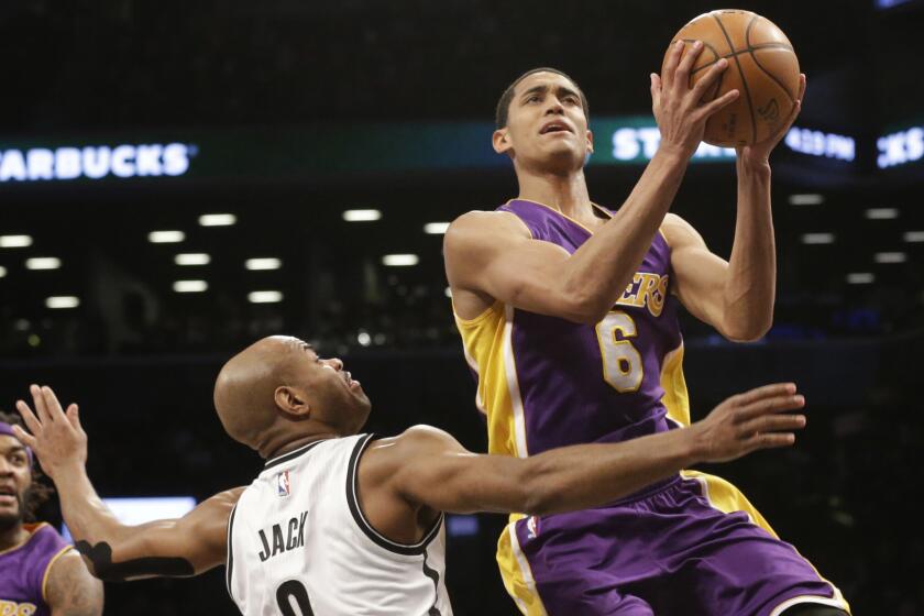 Lakers guard Jordan Clarkson, right, puts up a shot over Brooklyn Nets guard Jarrett Jack during the first half of a game on March 29, 2015.