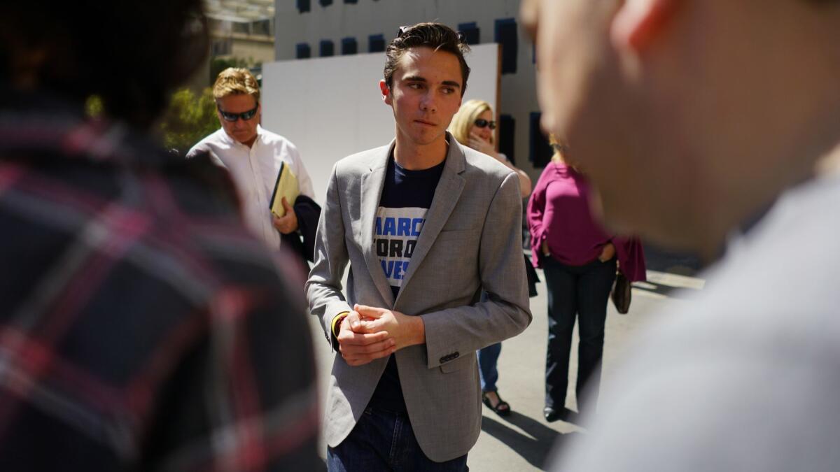David Hogg, who survived the shooting at Marjory Stoneman Douglas High School in Parkland, Fla., speaks with well-wishers at The Standard in downtown Los Angeles on Saturday, April 7.