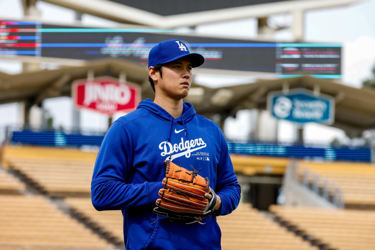 Shohei Ohtani stands on the field before a game between the Dodgers and Angels at Dodger Stadium.