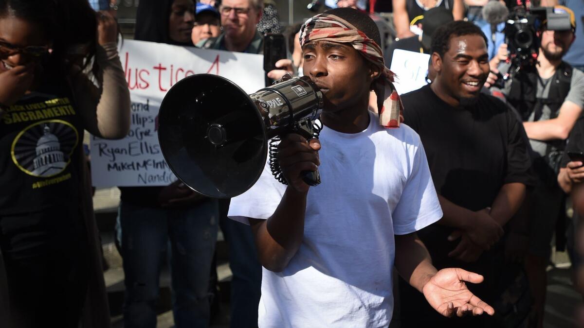 Stevante Clark was arrested Thursday for allegedly making threats and harassing 911 calls. Above, Clark speaks to Black Lives Matter protesters on the day of his brother's funeral in downtown Sacramento on March 29, 2018.