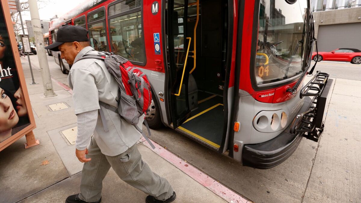 Passenger Ruben Villalobos departs the Metro Rapid Bus in downtown Los Angeles.