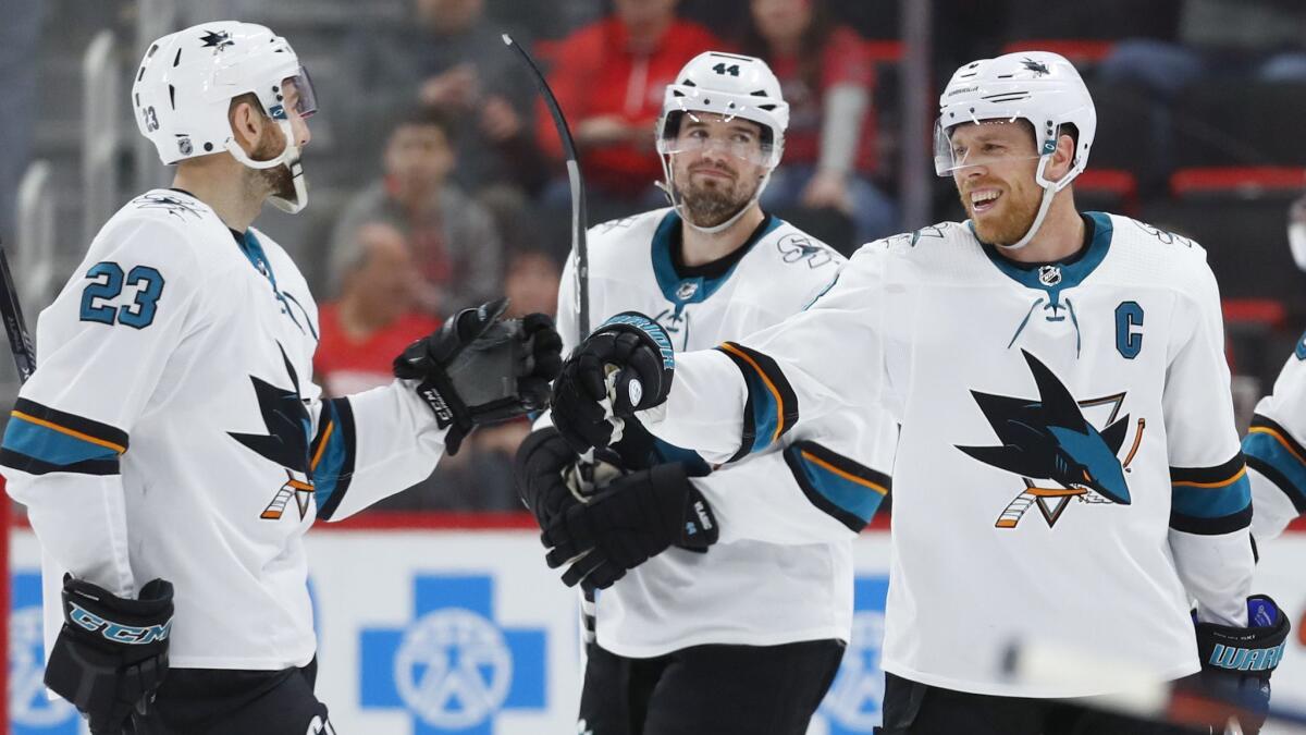 Sharks center Joe Pavelski, right, celebrates with teammate Barclay Goodrow, left, after scoring a goal against the Red Wings on Feb. 24.
