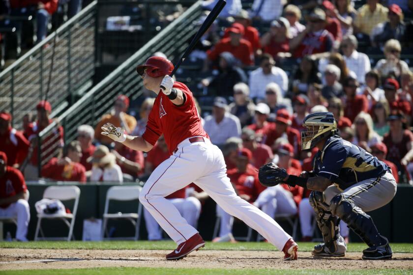 Angels first baseman C.J. Cron hits a double in a spring training game against the Brewers.