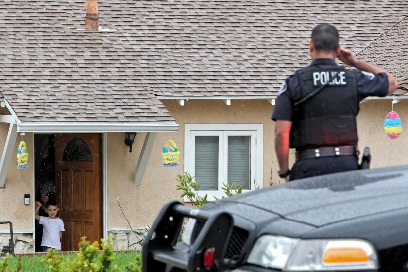 Glendale Police officer Vlad Akopian salutes Paxton Taylor Aguilera during a visit to the six-year old birthday-boy at his home in Glendale on Thursday, April 9, 2020. With his red and blue lights flashing and a light rain falling, officer Akopian and Aguilera salute each other after a few minutes of interaction. Because of the state-wide order to stay at home, AguileraOs birthday party was cancelled. Officer Akopian heard about it from a colleague and took it upon himself to wish the young boy a happy birthday.