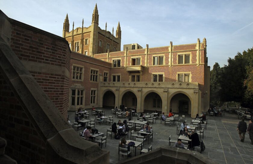 Students gather in a courtyard behind Kerckhoff Hall on the UCLA campus. The university received the most freshman applications of any U.S. public college this year.