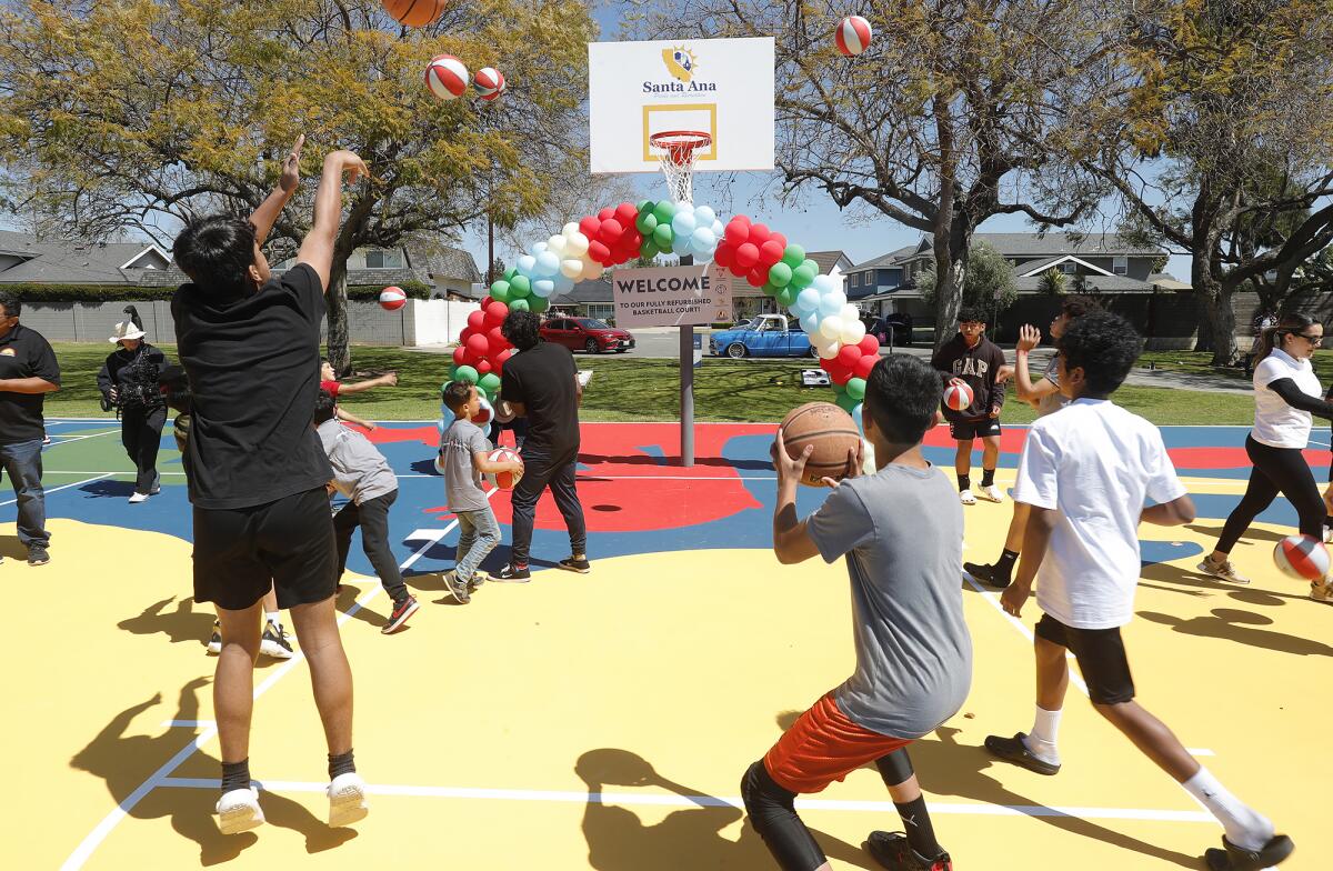 Kids of all ages take to the new “mural court” at Portola Park in Santa Ana on April 4.