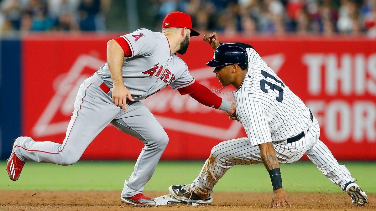 The Yankees' Aaron Hicks is tagged out trying to steal second base in the fifth inning by the Angels' Danny Espinosa.