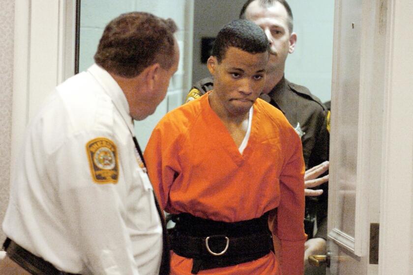 FILE - In this Oct. 26, 2004, file photo, Lee Boyd Malvo enters a courtroom in the Spotsylvania, Va., Circuit Court. A federal judge has tossed out two life sentences for D.C. sniper shooter Lee Boyd Malvo and ordered Virginia courts to hold new sentencing hearings. In a ruling issued Friday, U.S. District Judge Raymond Jackson in Norfolk said Malvo is entitled to new sentencing hearings after the U.S. Supreme Court ruled that mandatory life sentences for juveniles are unconstitutional. (Mike Morones/The Free Lance-Star via AP)