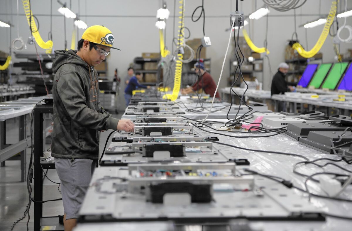 Michael Torres works on a television in the SunbriteTV factory in Newbury Park.