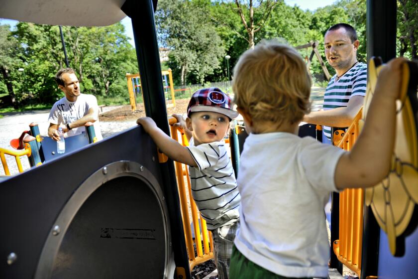 FILE - Henrik Holgersson, right, watches his son, Arvid, center with hat, play with Walter Johansson accompanied by his father Henrik Johansson at a playground in Stockholm, Sweden, Wednesday June 29, 2011. Fifty years after Sweden became the first country in the world to introduce paid parental leave for fathers, the Scandinavian country has launched a groundbreaking new law granting paid leave allowing grandparents and other legal guardians to care for a child. The law came into effect Monday, July 1, 2024, and allows parents to transfer some of their generous parental leave allowance to the child's grandparents or ‘bonus-parent’ — a term often used in Sweden for a step-parent. (AP Photo/Niklas Larsson, File)