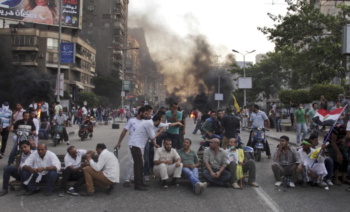 Supporters of ousted Egyptian president Mohammed Morsi sit in the street during a protest in Cairo.