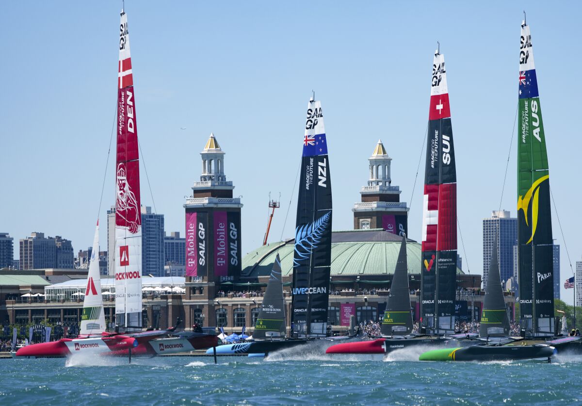 In this image provided by SailGP, the fleet sail past spectators at Navy Pier on Race Day 1 on Race Day 1 of United States Sail Grand Prix sailing race on Lake Michigan, Saturday, June 18, 2022, in Chicago. (Bob Martin/SailGP via AP)