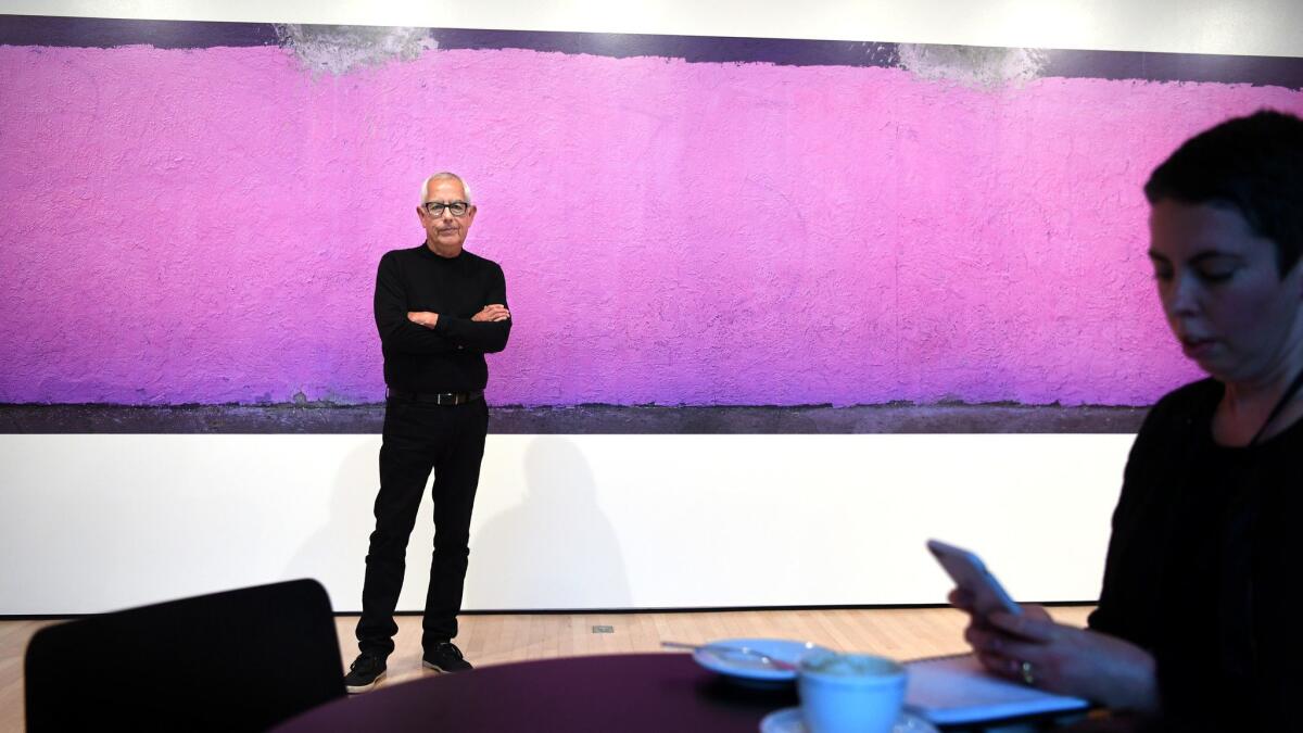 Photographer Anthony Hernandez pauses before one of his images during his solo exhibition at the San Francisco Museum of Modern Art in 2016.