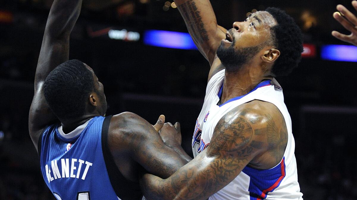 Clippers center DeAndre Jordan, right, reaches for a rebound as he is fouled by Minnesota Timberwolves forward Anthony Bennett during a game on Dec. 1, 2014.