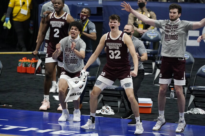 Mississippi State players celebrate on the bench after a score against Kentucky in the first half of an NCAA college basketball game in the Southeastern Conference tournament, Thursday, March 11, 2021, in Nashville, Tenn. (AP Photo/Mark Humphrey)