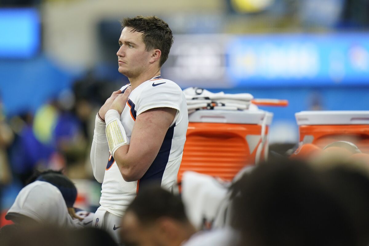 Denver Broncos quarterback Drew Lock stands on the bench in the closing minutes of a loss to the Los Angeles Chargers during an NFL football game Sunday, Jan. 2, 2022, in Inglewood, Calif. (AP Photo/Jae C. Hong)