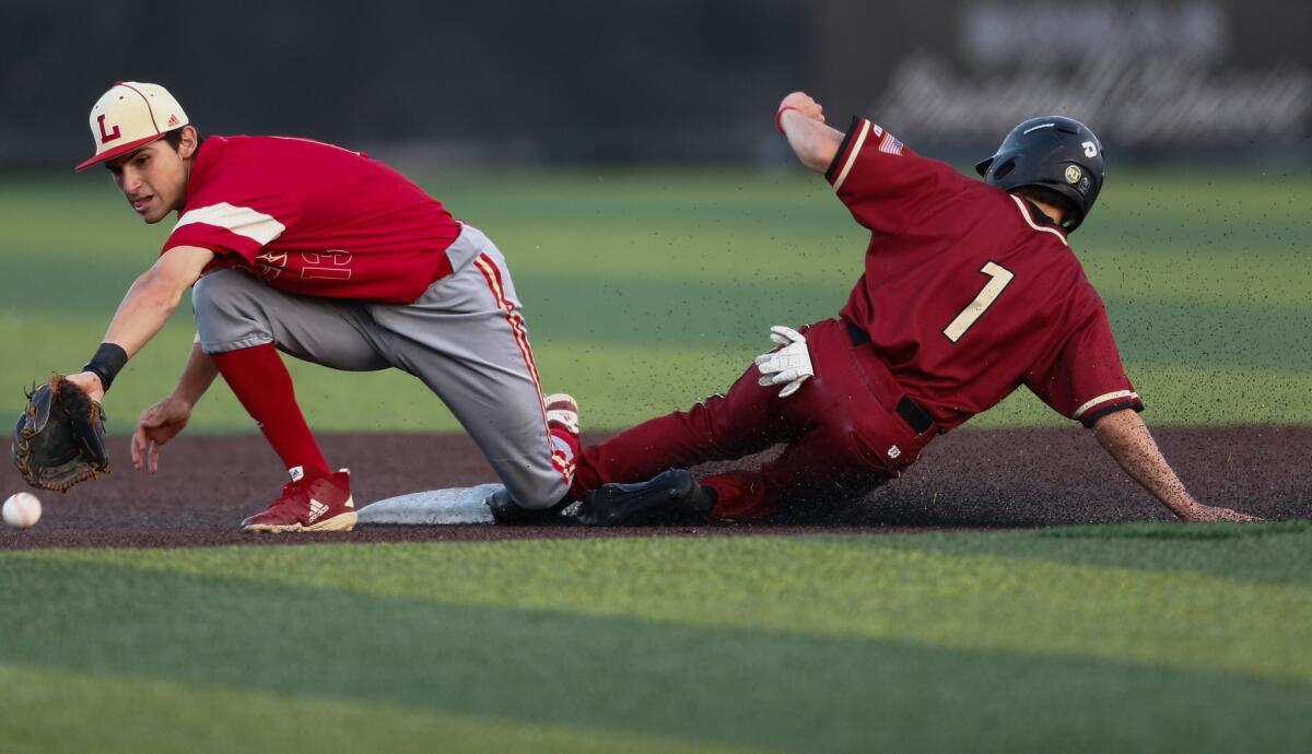JSerra's Jake Taylor (1) beats the throw to second base as Orange Lutheran's James Espalin fields the throw during a Trinity League game last week.