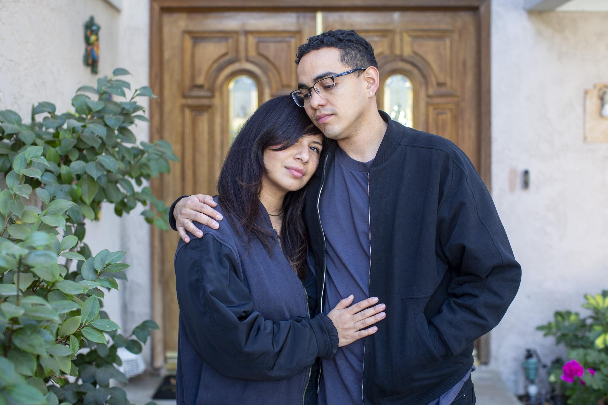 Danielle Stone and her husband, Bryan Davila, embrace at a relative's house in Hacienda Heights on Jan. 16.