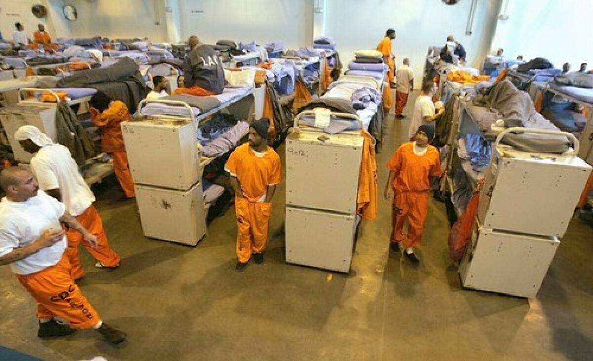 Inmate beds fill a gymnasium at the California State Prison in Lancaster. The Legislature is considering actions that would reduce the population of state prisons.