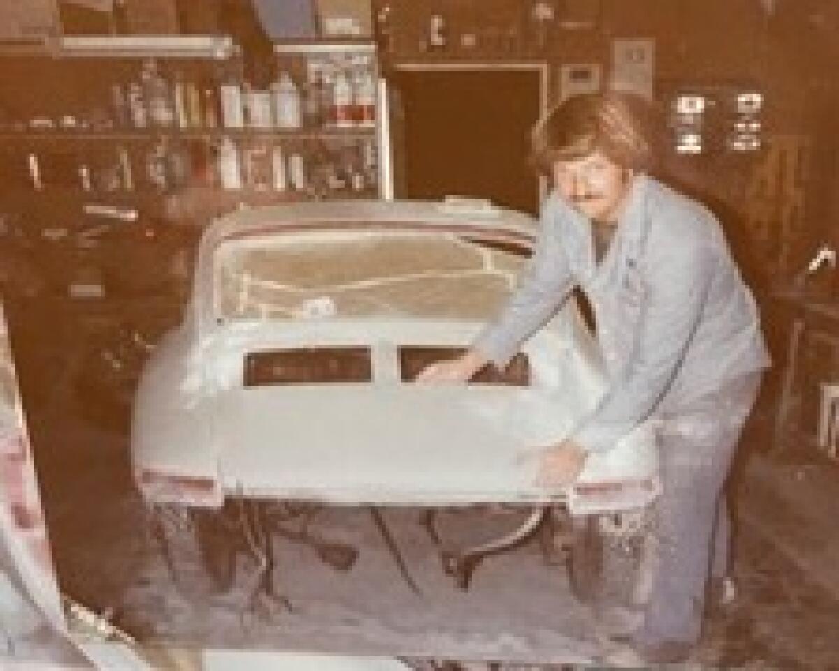 Former La Jollan Markham Speros is pictured decades ago working on a Porsche in San Diego.