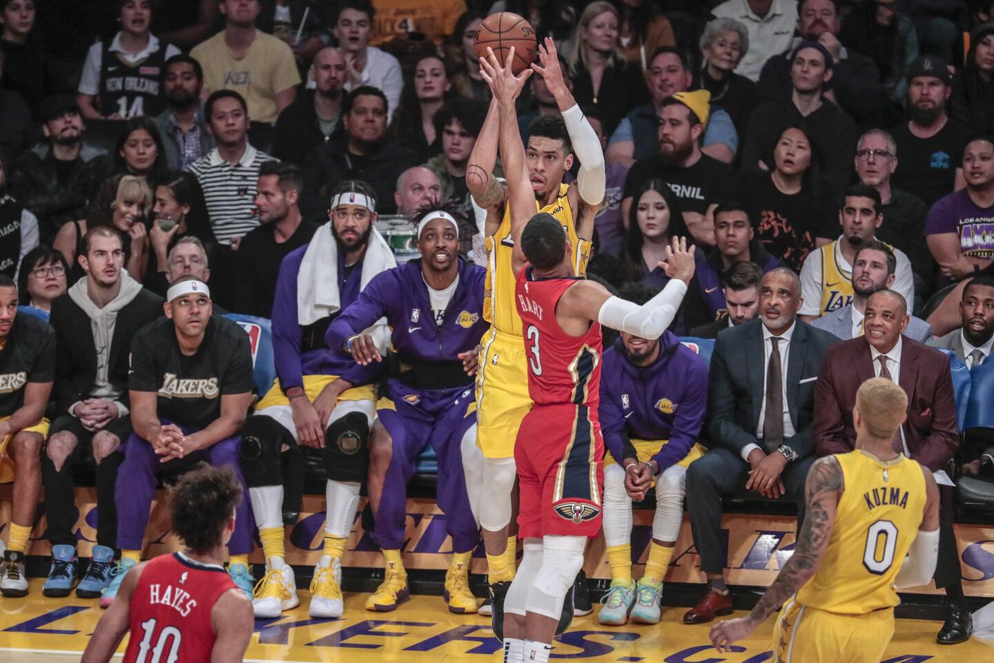 Lakers guard Danny Green shoots a three-pointer over New Orleans' Josh Hart. Green made five threes in the first half and finished the game with six.