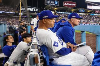 Los Angeles, CA, Sunday, October 6, 2024 - Dodgers manager Dave Roberts looks on from the dugout during a game against the San Diego Padres in game two of the National League Division Series at Dodger Stadium. (Robert Gauthier/Los Angeles Times)