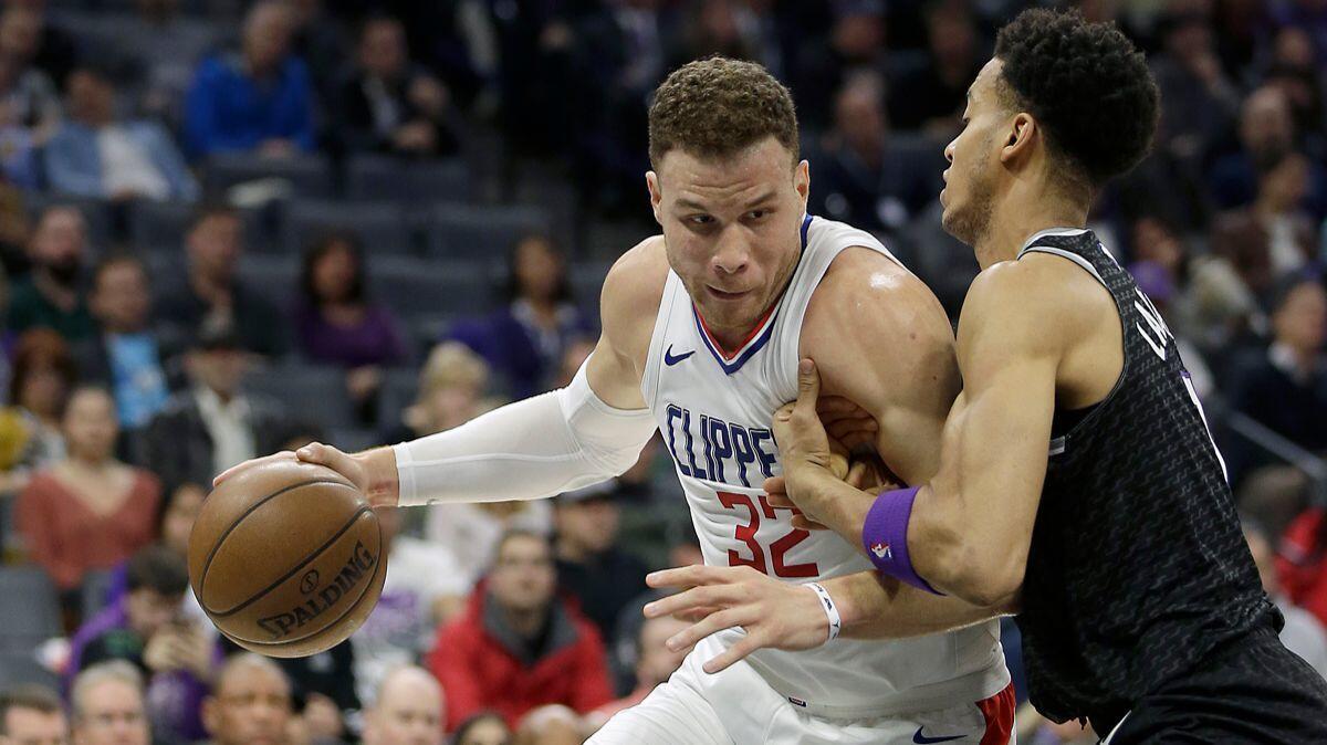 Clippers forward Blake Griffin, left, goes to the basket against Sacramento Kings forward Skal Labissiere during the first quarter on Thursday.
