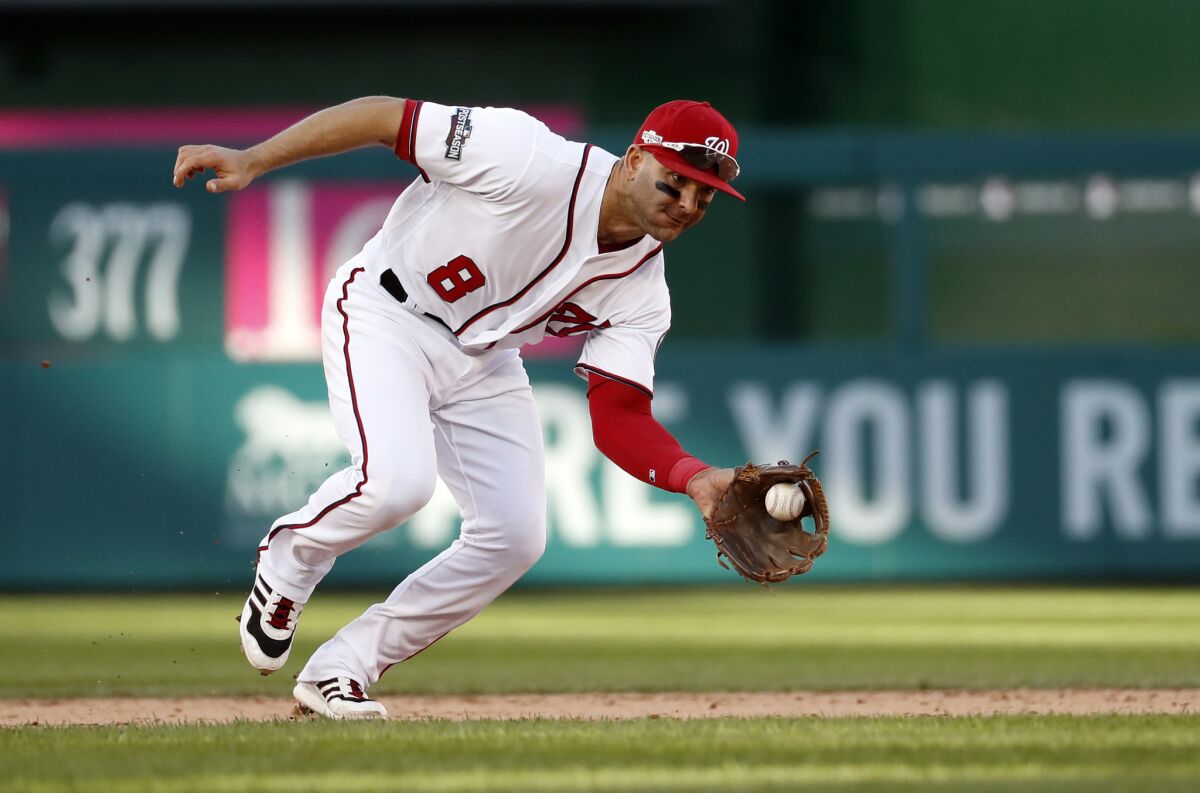 Washington Nationals shortstop Danny Espinosa (8) fields a ground ball during Game 2 of baseball's National League Division Series against the Los Angeles Dodgers, at Nationals Park, Sunday, Oct. 9, 2016, in Washington. The Nationals won 5-2.