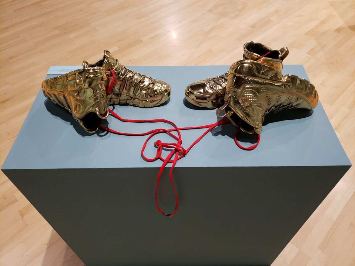 Kendell Carter, "Effigy for a New Normalcy, Love like Michael Loves Scottie," 2018, gold-plated basketball shoes, shoe laces