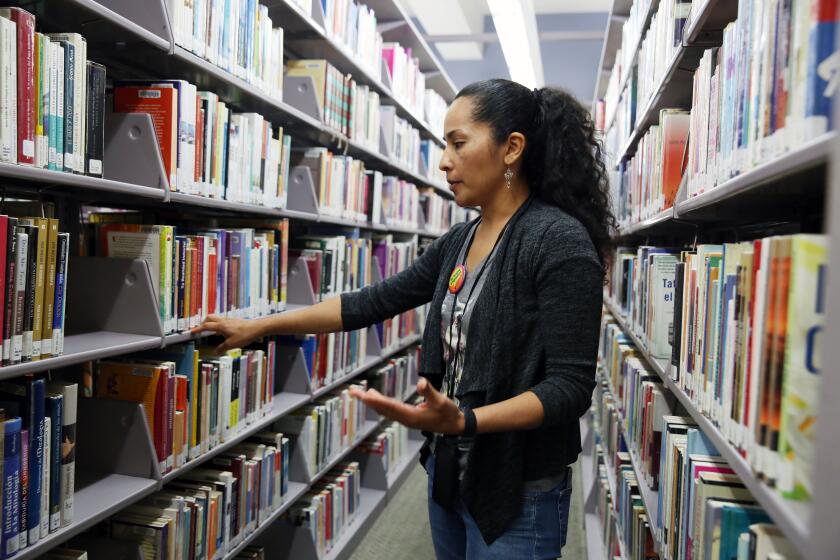 LOS ANGELES, CA-JUNE 14, 2019: Senior Librarian Ana Campos looks for a book that might not have been available to them five years prior in the International Languages Department at the Central Branch of the Los Angeles Public Library on June 14, 2019, in Los Angeles, California. (Photo By Dania Maxwell / Los Angeles Times)