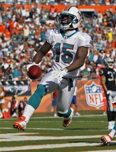Miami Dolphins wide receiver Davone Bess (15) celebrates his touchdown against the Oakland Raiders during the first half of an NFL football game on Sunday, Dec. 4, 2011, in Miami , Fla. (AP Photo/Wilfredo Lee)