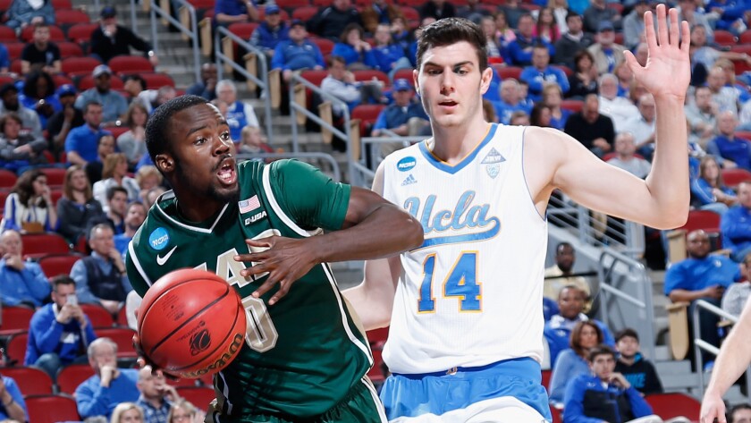 UCLA forward Gyorgy Goloman tries to cut off a drive by Alabama Birmingham's Hakeem Baxter during the Bruins' 92-75 win in the third round of the NCAA tournament South Regional on March 21, 2015.