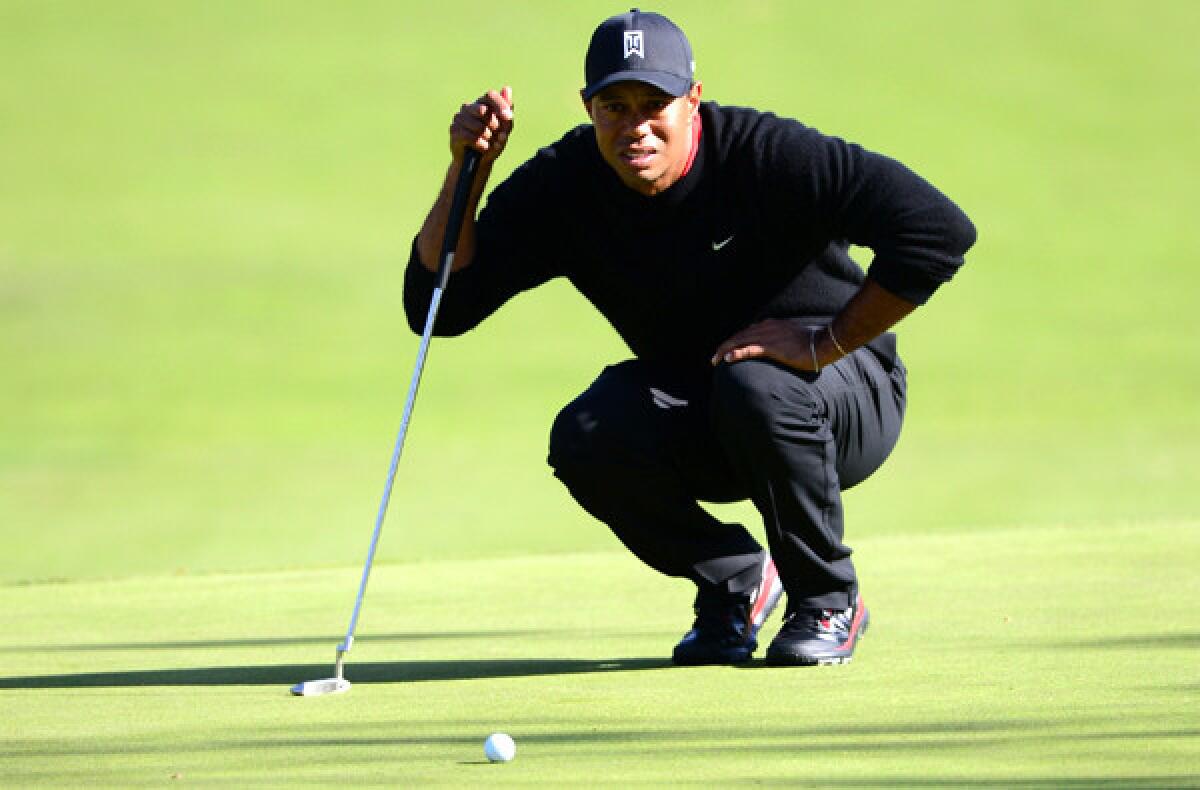 Tiger Woods lines up a putt at the fifth hole Sunday in the final round of the Northwestern Mutual World Challenge at Sherwood Country Club in Thousand Oaks.