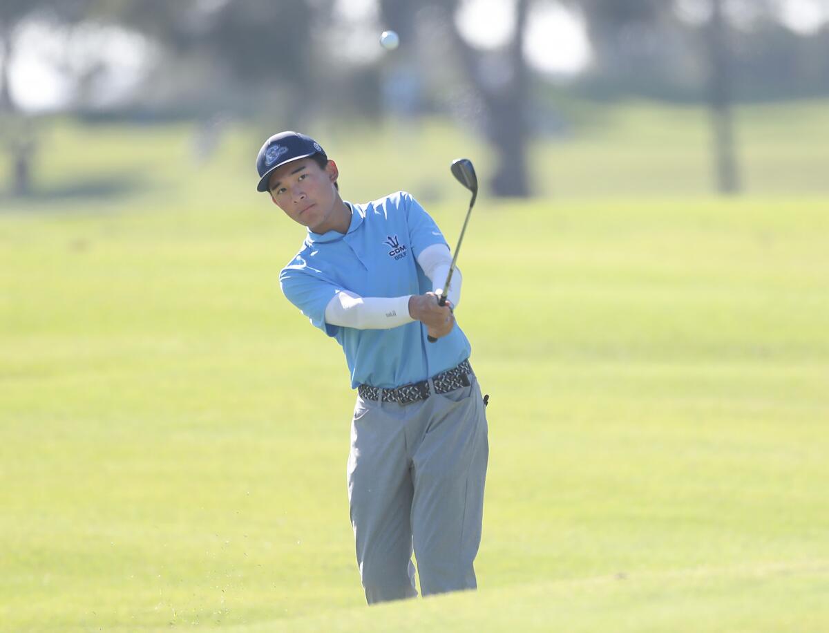 Steven Yang of Corona del Mar hits a shot close to the pin against Newport Harbor on Wednesday at Costa Mesa Country Club.